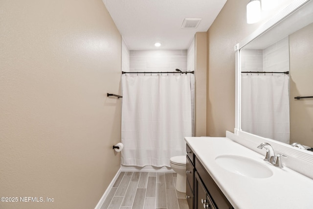 full bathroom with hardwood / wood-style flooring, vanity, toilet, and shower / tub combo