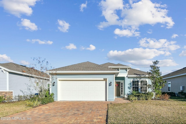 view of front of property with a garage and a front yard