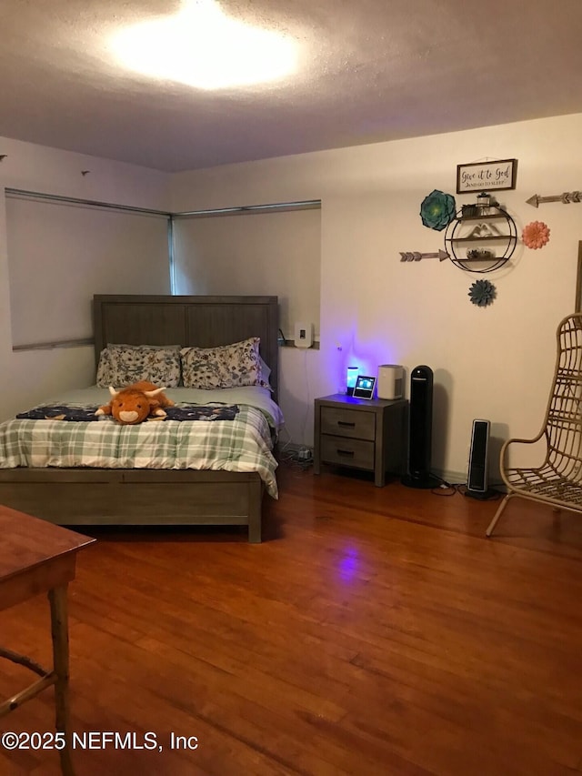 bedroom featuring dark wood-type flooring