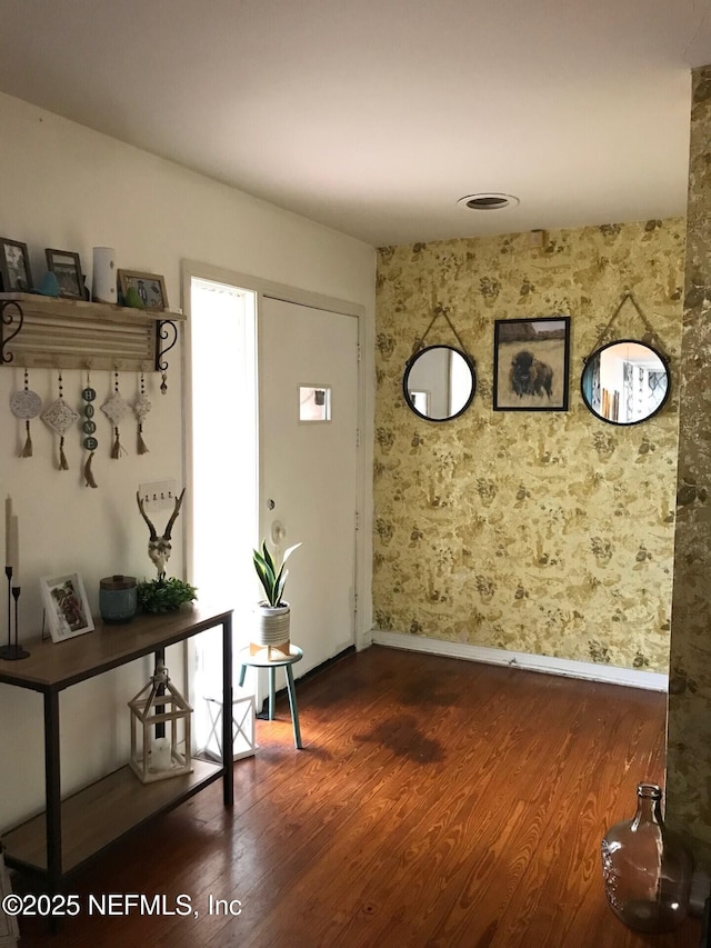 foyer entrance featuring dark wood-type flooring