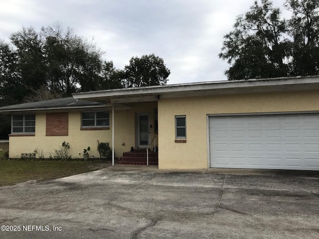 single story home with a garage