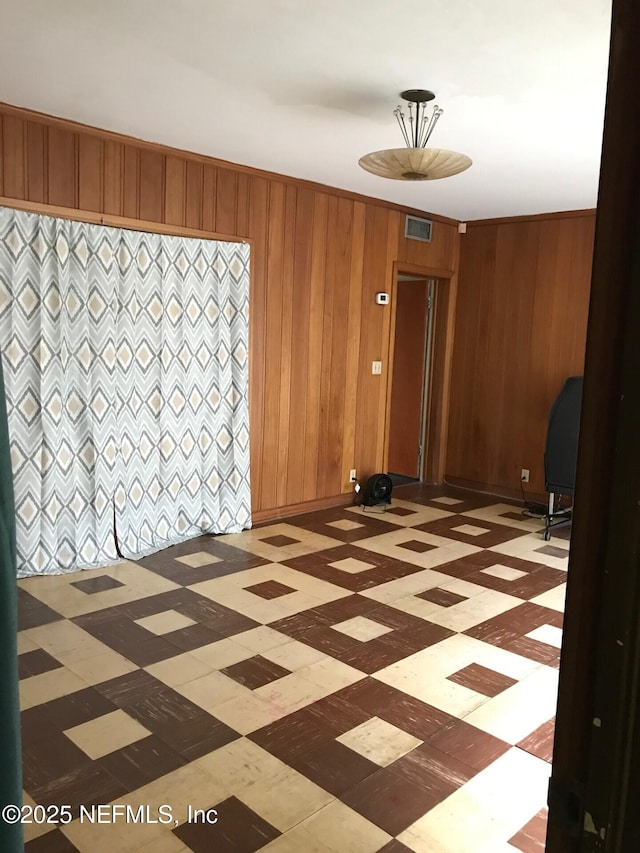 unfurnished room with wood walls