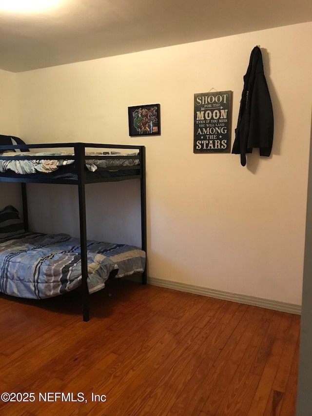 bedroom with hardwood / wood-style floors