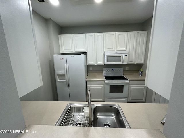 7801 Point Meadows Dr Unit 1101, Jacksonville, FL 32256 - kitchen featuring white cabinets, white appliances, and sink