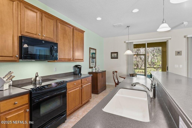 kitchen featuring a textured ceiling, black appliances, sink, hanging light fixtures, and light tile patterned flooring