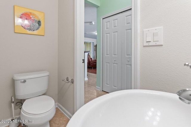 bathroom featuring toilet and tile patterned floors