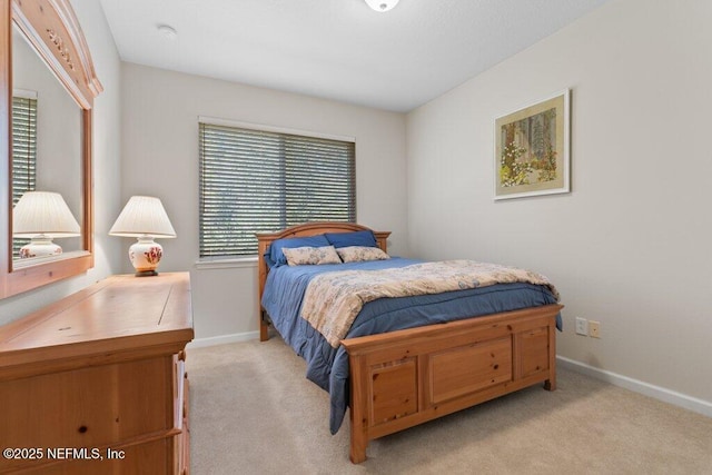 bedroom featuring light carpet