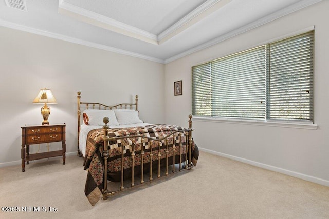 bedroom with a raised ceiling, light colored carpet, and crown molding