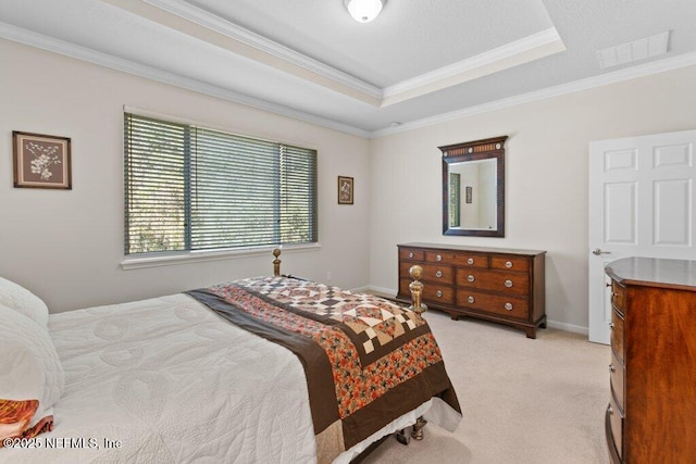 bedroom with light colored carpet, ornamental molding, and a raised ceiling