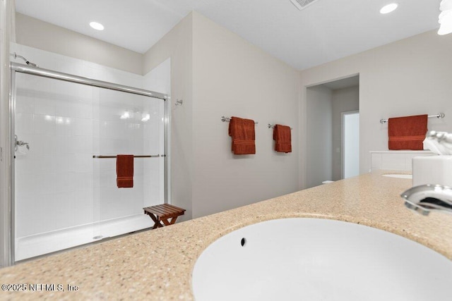 bathroom featuring an enclosed shower and vanity