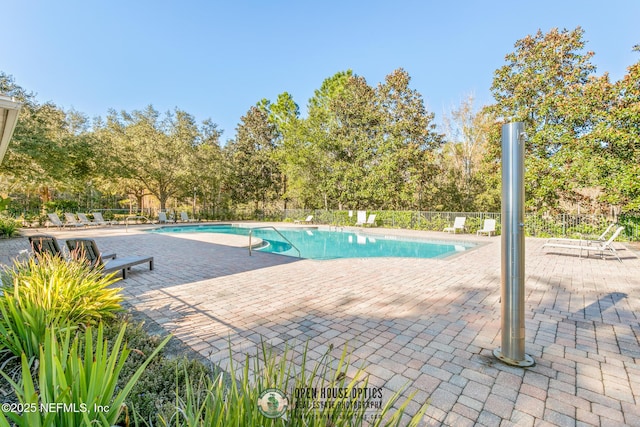 view of swimming pool with a patio area