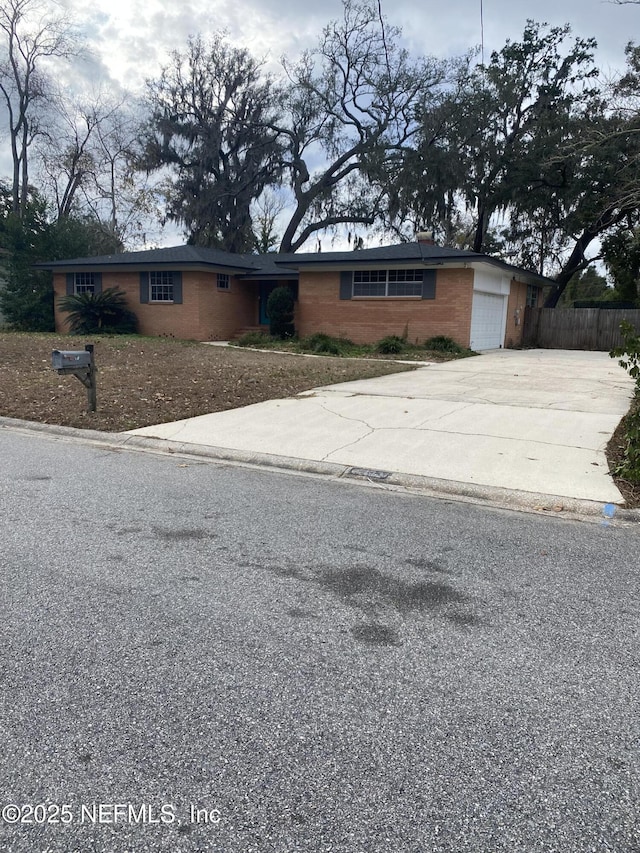 ranch-style house featuring a garage