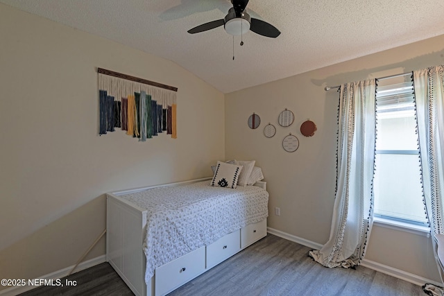 bedroom featuring wood-type flooring, a textured ceiling, ceiling fan, and lofted ceiling