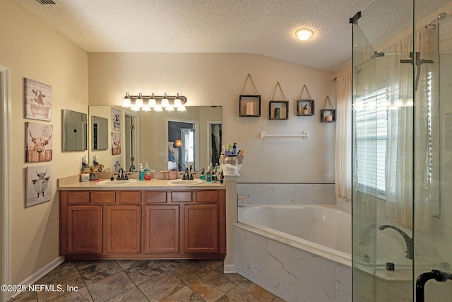 bathroom with vaulted ceiling, vanity, a textured ceiling, and shower with separate bathtub