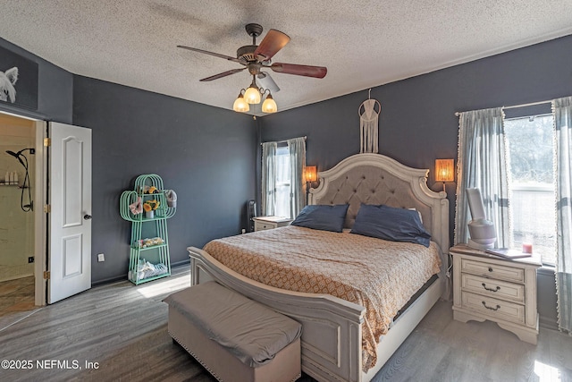 bedroom with ceiling fan, light hardwood / wood-style flooring, and a textured ceiling