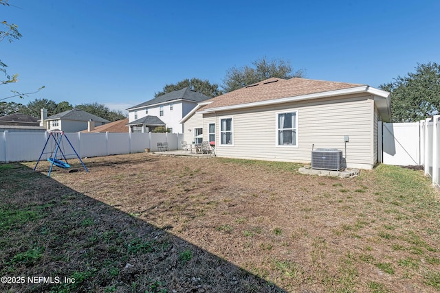 rear view of house with a yard, a patio, a playground, and cooling unit