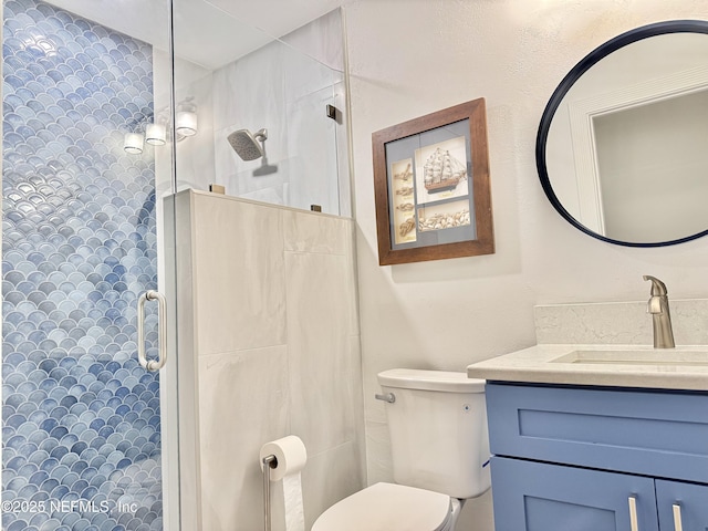 bathroom with an enclosed shower, vanity, and toilet