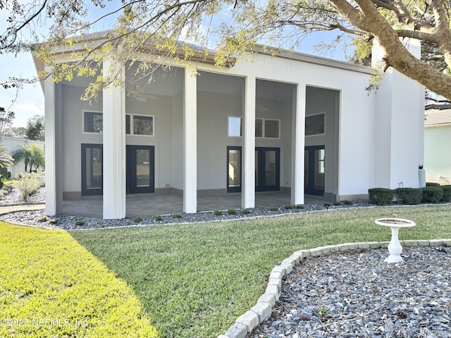 rear view of property featuring a yard and a patio area