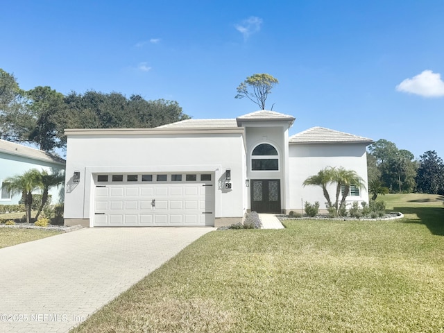 view of front of property with a garage and a front yard