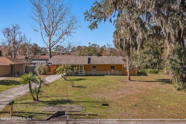 single story home with stucco siding, driveway, and a front lawn