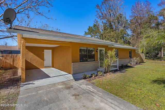 ranch-style home with a carport and a front lawn