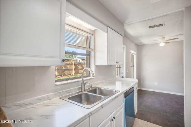 kitchen with a sink, light countertops, white cabinetry, and stainless steel dishwasher