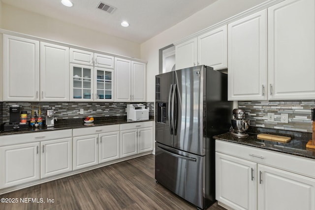 kitchen featuring tasteful backsplash, white cabinetry, and stainless steel refrigerator with ice dispenser