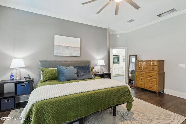 bedroom with ensuite bath, ceiling fan, dark hardwood / wood-style flooring, and ornamental molding