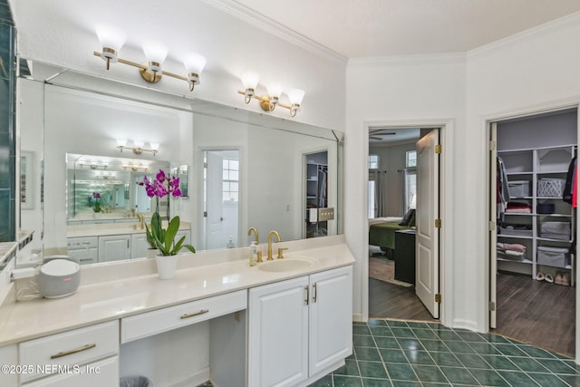 bathroom with tile patterned flooring, a healthy amount of sunlight, vanity, and crown molding