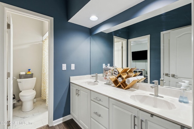 bathroom featuring vanity and toilet