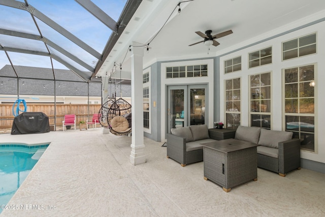 view of patio featuring glass enclosure, ceiling fan, a grill, an outdoor living space, and a fenced in pool