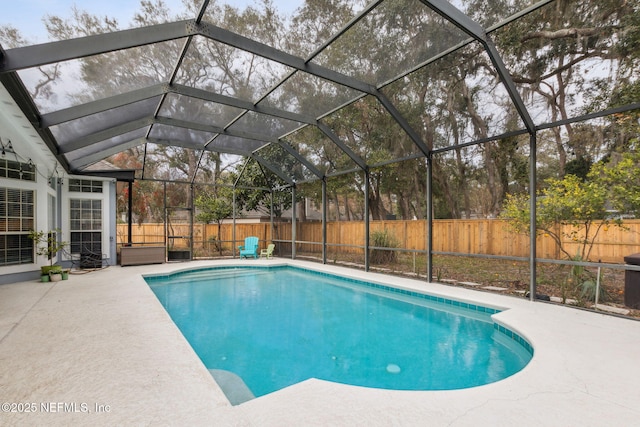 view of pool with a patio and a lanai