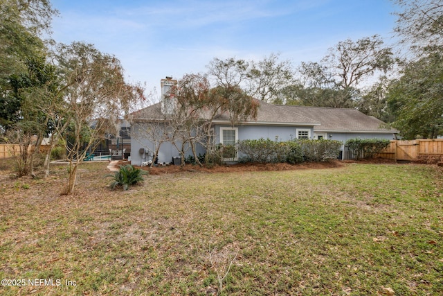 back of house featuring a lawn