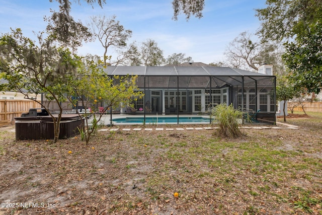 view of yard with a fenced in pool and glass enclosure