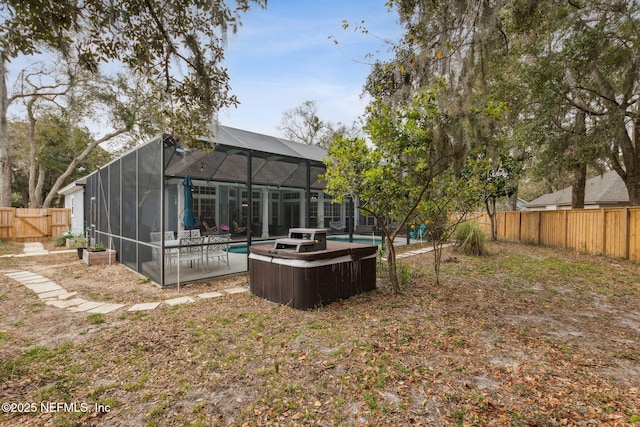 view of yard featuring a fenced in pool and glass enclosure