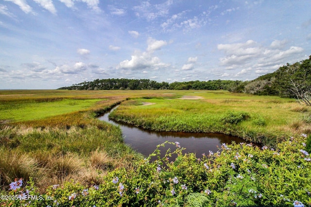 surrounding community featuring a water view and a rural view