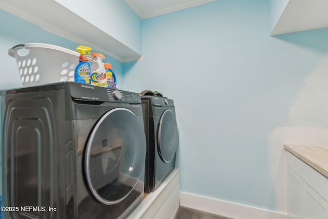 laundry room with washing machine and clothes dryer and ornamental molding