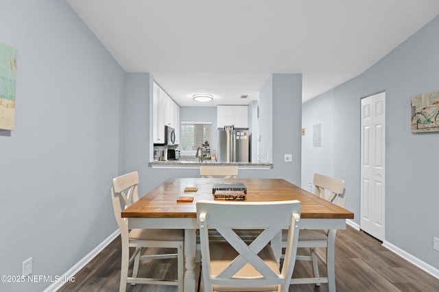 dining room with dark hardwood / wood-style floors