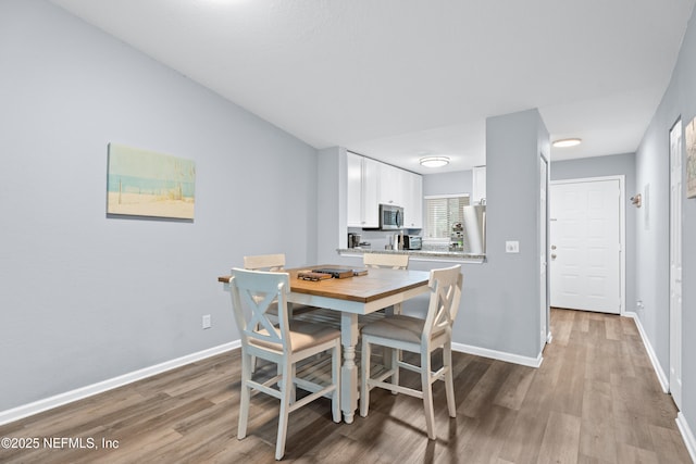 dining area with light hardwood / wood-style flooring