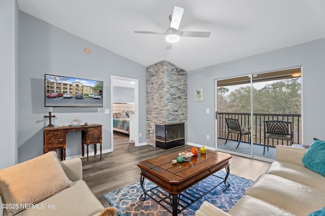 living room featuring ceiling fan, lofted ceiling, and wood-type flooring