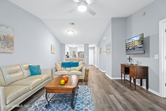 living room featuring ceiling fan, vaulted ceiling, and hardwood / wood-style floors