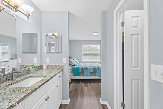 bathroom with a chandelier, vanity, and wood-type flooring