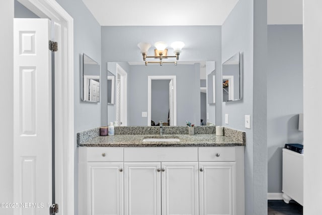 bathroom featuring vanity and a chandelier