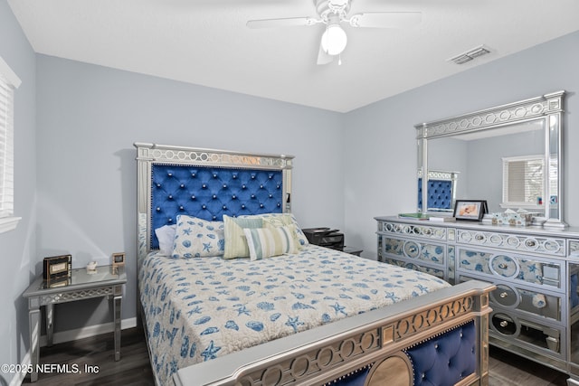 bedroom with ceiling fan and dark hardwood / wood-style flooring