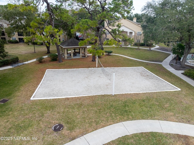 surrounding community with a lawn, volleyball court, and a gazebo