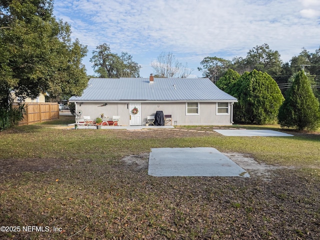 back of house featuring a patio and a lawn