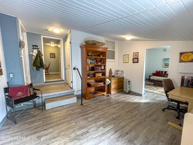 office featuring built in shelves and hardwood / wood-style floors