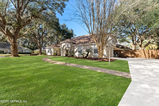 ranch-style home with a front lawn