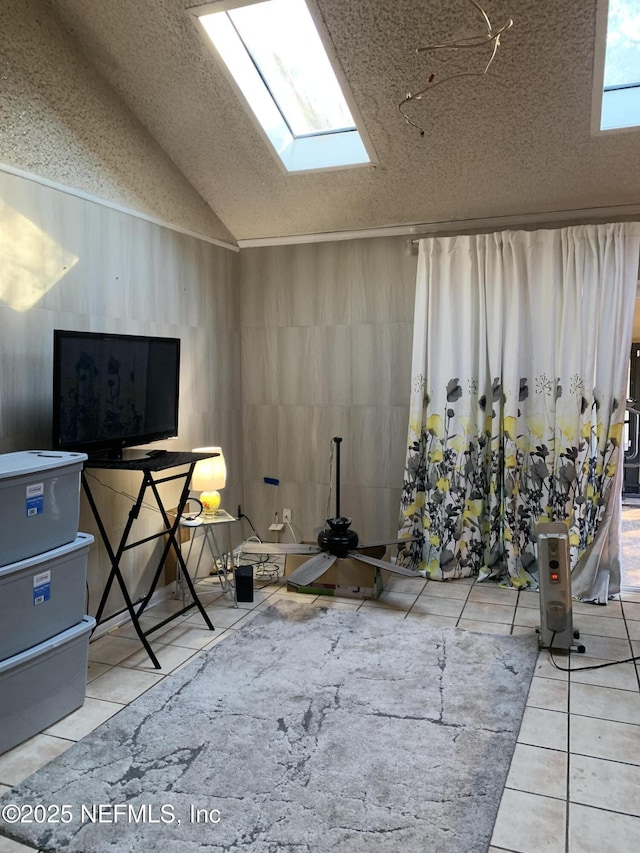 workout room with tile patterned flooring and lofted ceiling with skylight