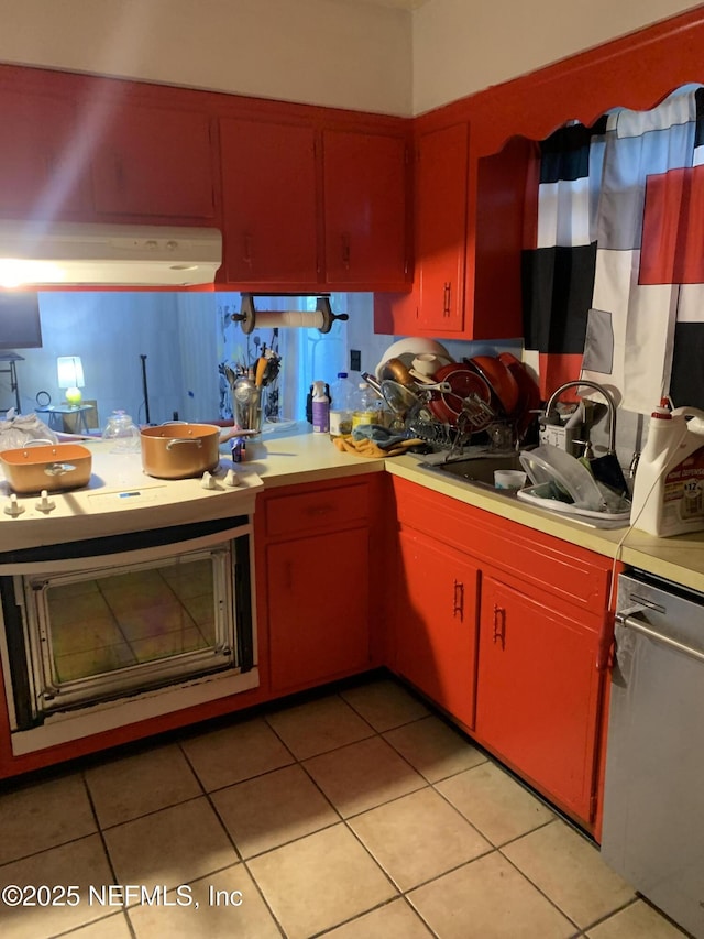 kitchen with light tile patterned flooring, sink, and stainless steel dishwasher